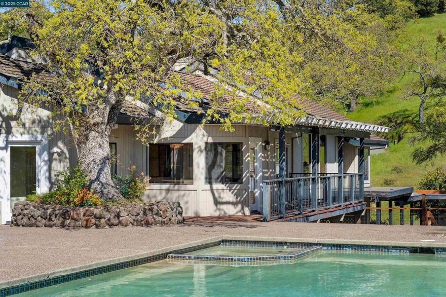 Expansive Burton Valley Retreat with Endless Potential. Nestled in the scenic hills of Burton Valley, this 5-bedroom, 3.5-bathroom home offers an incredible opportunity to refresh and reimagine a private estate on 4 + acres. Tucked at the end of a scenic driveway, the home feels worlds away while remaining just minutes from Downtown Lafayette and Walnut Creek. The spacious floor plan features soaring ceilings, walls of glass, and an atrium entry with a built-in water feature. The main living spaces include a family room and living room, both with fireplaces and access to a shared deck plus dining room, kitchen with an island, breakfast nook, and a built-in desk. A convenient wet bar near the pool area makes entertaining a breeze. The primary suite enjoys its own private deck, fireplace, and an en-suite bath with a soaking tub, walk-in shower, dual sinks, and a generous closet. 4 additional bedrooms offer flexibility for guests, family, or office space. Create your outdoor oasis with a pool, and spa, deck, and terraced yard space overlooking the rolling hills. A rare 5-car garage, divided into three sections, provides ample storage and workspaces. Near top-rated schools, parks, trails, local swim club, & equestrian center. This home offers an exciting chance to create your dream!