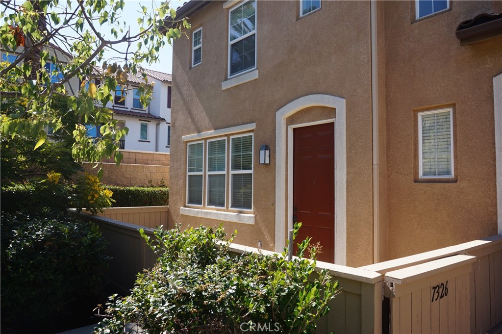 This Spanish architectural designed townhouse has two ensuite bedrooms and a guest powder room on two levels. The lower level is divided into a living room, dining room, kitchen, and powder room. The upper level has two bedrooms with private bathrooms. Bedroom 1 has a walk-in closet. The stacked washer and dryer appliances are located on the second floor. The exterior features a front patio with a natural gas hookup for a BBQ, and gated security entry into the development. The parking consists of a 2-car garage and a 2-car driveway. The interior is well-maintained with ceramic tile flooring throughout the lower level and wall-to-wall carpeting on the upper level. This home is conveniently located near shopping and local beaches.