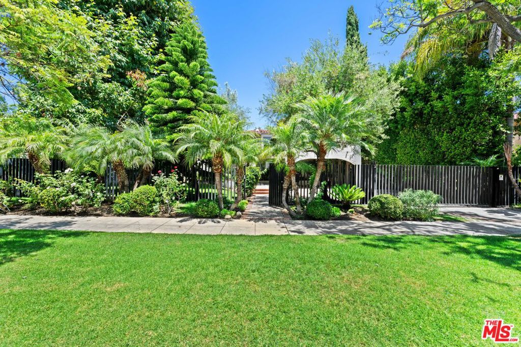 Hollywood Regency Gem in the Heart of Beverly Hills. Step into timeless elegance at this beautifully maintained, authentic Spanish estate, the former home of Jean Harlow!! Located in prime Beverly Hills, this 6-bedroom, 9-bath residence exudes charm, character, and architectural integrity. The spacious den with fireplace opens to a large deck with a retractable awning, perfect for indoor-outdoor entertaining. A saltwater pool anchors the lush backyard, creating a true private oasis. The luxurious primary suite features dual bathrooms, a steam shower, and an expansive walk-in closet. Additional highlights include : A two-story guest house with private balcony. Electric vehicle charger. Gas generator with extra fuel tanks. ADT alarm system with security cameras. Gated and secure for maximum privacy. No sign on the property. Shown only to qualified buyers. If only these walls could talk!!