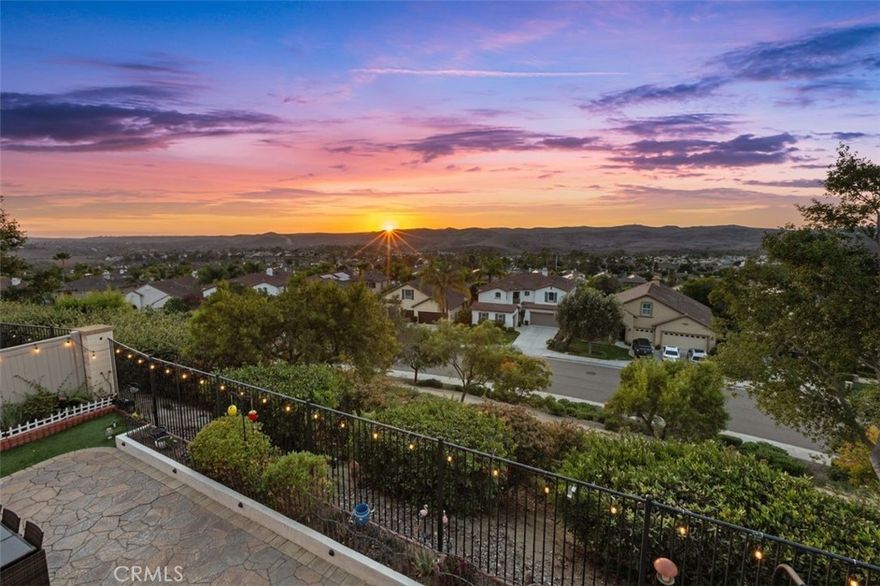 PANORAMIC SUNSET VIEWS! SPACIOUS LAYOUT! DOWNSTAIRS ENSUITE! Located in the highly desirable Arrowood Community, this stunning 4-bedroom, 3.5-bath home offers 3,080 sq. ft. of beautifully designed living space with breathtaking westerly hilltop views. The open-concept kitchen features granite countertops, a large center island with bar seating, stainless steel appliances, and rich dark wood cabinetry, all complemented by engineered hardwood floors downstairs. It flows seamlessly into a spacious family room with a cozy fireplace and a large dining room, perfect for gatherings and entertaining. A first-floor ensuite bedroom provides flexibility for guests or multigenerational living. Upstairs, the spacious primary suite offers a private balcony, walk-in closet, soaking tub, separate shower, and dual vanities. The upper level also features luxury vinyl plank flooring, an additional family room, an upstairs office, and an upstairs laundry room. Step outside to your entertainer’s backyard, featuring artificial grass, a gazebo, fire pit, BBQ grill, and a bar area with refrigerator and sink—all framed by unobstructed panoramic sunset views. The home also includes a 3-car garage and Solar panels providing energy efficiency and cost savings. Residents of Arrowood enjoy resort-style amenities, including a Jr. Olympic-sized pool, clubhouse, walking trails, and community parks. Golf enthusiasts will love the nearby Arrowood Golf Course, one of North County’s most scenic and playable courses. Low HOA and served by the award-winning Bonsall School District, with Bonsall West Elementary conveniently located adjacent to the community.