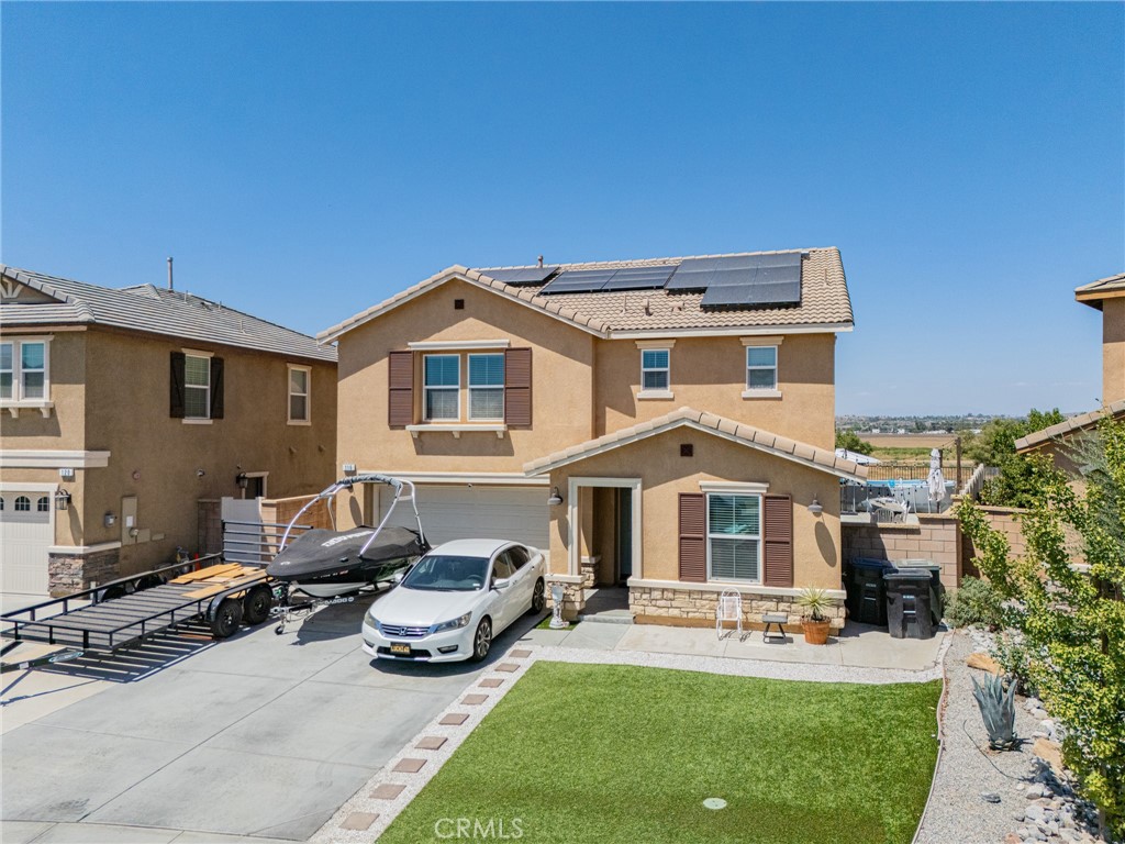 This 2,376 sq. ft. home is filled with upgrades and thoughtful touches throughout, beginning with the stunning fully remodeled kitchen—the true heart of the home. Featuring quartz countertops, a striking full-wall white backsplash, floating wood shelves, gold hardware, stainless steel appliances, and a spacious waterfall island, this kitchen perfectly balances modern style and everyday functionality. The pantry is enhanced with a charming wood barn door for added character. The open-concept design connects the kitchen seamlessly to the dining and living areas, while the downstairs includes a versatile bonus room—ideal for a home office or guest space—plus a convenient guest restroom. French doors lead to a private backyard complete with an Alumawood patio cover and no rear neighbors. Upstairs, the primary suite offers a large walk-in closet, dual sinks, and a walk-in shower. A loft provides additional living space, and the creative converted playroom under the stairs adds a fun, unique touch. The home also includes 18 solar panels for energy efficiency and plenty of driveway parking.Situated in Monument Park with no HOA, this home is close to parks, schools, and shopping. Don’t miss the recent price reduction and be sure to check out the new virtual tour!
