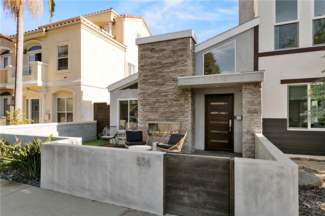 This beautifully upgraded Downtown Huntington Beach home offers the best of beach-close living. With exceptional curb appeal, it features high-end finishes like a custom stacked stone exterior, porcelain tile floors, Ipe wood gates, skylights, and custom folding doors. The enclosed front patio is perfect for enjoying the ocean breeze by the fireplace. Inside, natural light pours in through large windows and vaulted ceilings, highlighting the open floor plan that flows into a kitchen with soft-close cabinets, granite countertops, and stainless steel appliances. Panoramic folding doors open to a private interior patio, ideal for entertaining. The updated bathroom features subway tile, and both guest bedrooms are spacious, with one overlooking the patio. The primary bedroom includes an en-suite bath with dual sinks. Just a short walk to Pacific City, Main Street, and the beach, this home offers the ultimate coastal lifestyle.