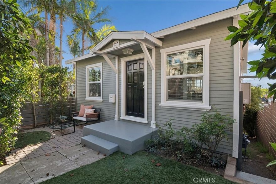 This beautifully remodeled coastal home sits in the heart of South Redondo Beach and welcomes you with charming curb appeal and a bright modern interior that blends beachside style with comfortable everyday living. The upstairs level features an open kitchen with shaker cabinetry, stainless appliances, a peninsula with seating, and picture windows that bring in natural light and palm tree views, all flowing into a warm and inviting living area with skylights and clean designer finishes. Two serene bedrooms connect through a spacious Jack and Jill bathroom finished with updated marble style tile and a glass enclosed shower, while the rear door opens to a peaceful balcony that captures breezes and sun throughout the day. The lower level feels like a private retreat with a full studio style layout complete with its own beautifully updated kitchen, a relaxing living and sleeping area anchored by a sleek modern fireplace, and direct access to the backyard. The yard is surrounded by lush greenery for privacy and features paver stone patios, an outdoor lounge area perfect for entertaining, and a hot tub for enjoying warm South Bay evenings. A washer and dryer setup located in the backyard shed adds convenience and storage. Whether used as one cohesive home with multiple living spaces or as two separate units with income or guest potential, this property offers rare flexibility in an exceptionally walkable location just minutes from the beach, the Esplanade, the Redondo Pier, top rated schools, and the boutiques and restaurants of Riviera Village, creating the ideal South Redondo lifestyle.
