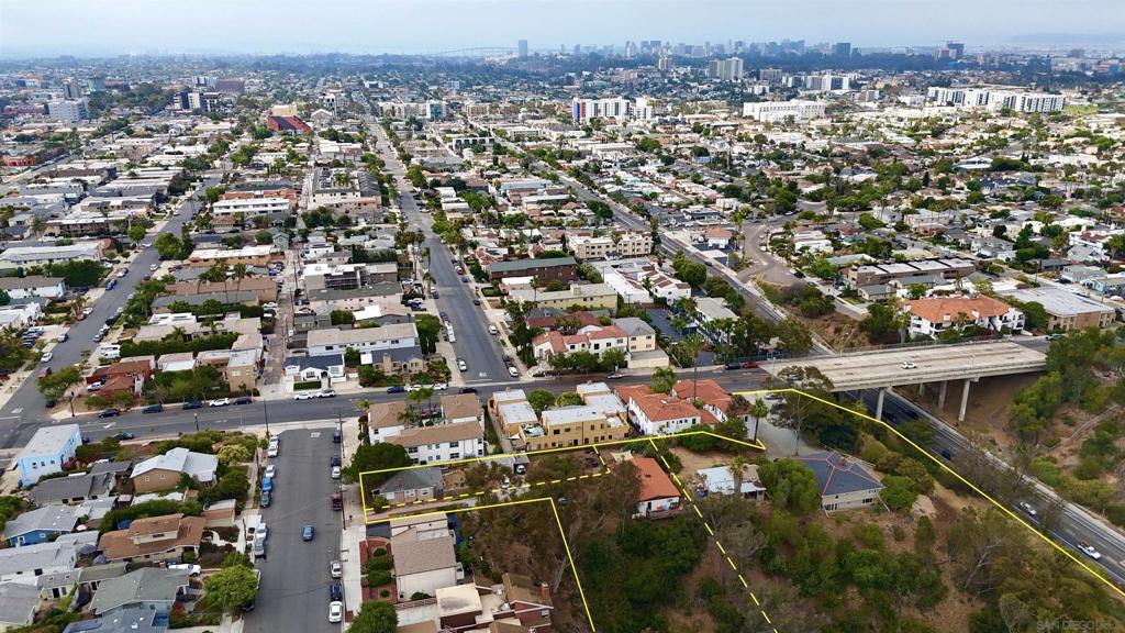 Fully occupied and income-producing, the Arizona Street parcels at 4712 & 4714–16 Arizona St offer a rare 23,000 SF development opportunity in the heart of University Heights. This double-lot site presents a compelling blend of stable in-place income and long-term redevelopment potential in one of San Diego’s most desirable infill neighborhoods. The property currently generates $8,125/month from a remodeled single-family home and a well-maintained duplex. Much of the site is dedicated to surface parking, creating a clear path for higher-density residential development. Plans have been submitted to the City of San Diego for 18 two-story ADU townhome units (nine duplex-style buildings), streamlining the path for a buyer to execute on a shovel-ready strategy—or adapt the site for their own vision. Located within a Transit Priority Area and zoned RM-1-1, the site benefits from reduced parking requirements and enhanced density options. This site is available individually or as part of a larger 3.14-acre portfolio when combined with the adjacent 2436 Adams Avenue property, which features an additional 16 entitled units. Together, the assemblage offers 34 proposed units across three prime parcels. Whether acquired separately or as part of a larger play, this is a standout opportunity for developers and investors seeking immediate income with entitlement upside in central San Diego.