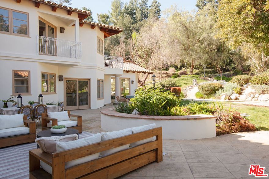 Sold off-market, entering for comp purposes only. Located in the prestigious guard-gated community of Hidden Hills, this 5,700+ sq. ft. Mediterranean estate offers 5 bed and 5 bath and is replete with a gorgeous living room with cathedral wood-beamed ceilings, an updated chef's kitchen with stainless steel appliances, and an oversized primary suite with separate sitting area. The picturesque 1+ acre lot boasts manicured grounds, grassy lawns, a resort-style pool with built-in slide and waterfall, outdoor kitchen, and multiple lounging areas. 3-car garage with additional driveway parking.