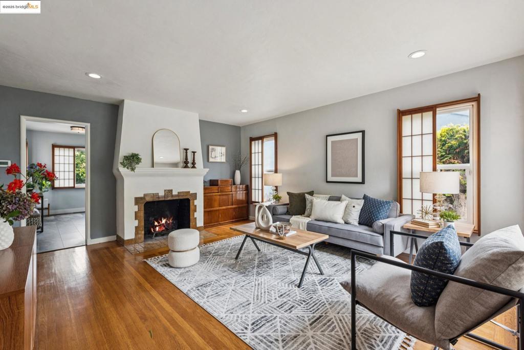 Step into serenity at 2416 Valley Street, a charming Berkeley home that blends classic warmth with elegant Japanese-inspired design. This delightful two-bedroom, one-bathroom residence features original hardwood floors, a cozy fireplace, and large, light-filled windows with soft Shoji-style coverings. The peaceful vibe begins at the vibrant red front door and flows throughout the thoughtfully designed interior. Tucked on a tree-lined street, the home includes an attached garage and a spacious laundry room with direct entry. The backyard reveals a beautifully manicured garden with mature plum, apple, persimmon, and lemon trees and a multitude of flowers—ideal for morning tea or evening reflection. At the heart of this oasis is a detached Japanese tea house cottage with tatami mats and traditional screens—perfect for a retreat, studio, or guest space*. With recent electrical upgrades and a newer roof, the home offers modern comfort with timeless charm. *Per graphic design : main house 1,040 sq ft + detached 227 sq ft = total 1,267 sq ft. Buyer to investigate.