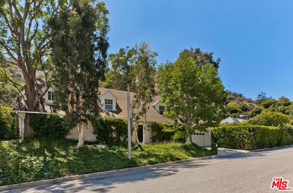 Nestled in the beautiful canyon of lower Bel Air 1041 Chantilly Rd is a 2 story 4 bedroom 6 bathroom home, just under 3,000 sqft! Beautifully maintained and move-in ready, this lower Bel Air home blends luxury, privacy, and traditional California charm. All bedrooms are upstairs all with ensuite bathrooms. Downstairs you will find a living room with fireplace, a family room with fireplace & wet bar, a formal dining room & cozy kitchen. The 2 car garage offers direct access to the home off the kitchen, which is convenient for grocery unloading! Access to the yard is from both the living room & kitchen. This private backyard oasis includes a swimming pool, spa, and multiple spaces for al fresco dining and relaxation all surrounded by mature greenery. A compelling opportunity to experience timeless elegance and serene living in one of Bel Air's most desirable locations.