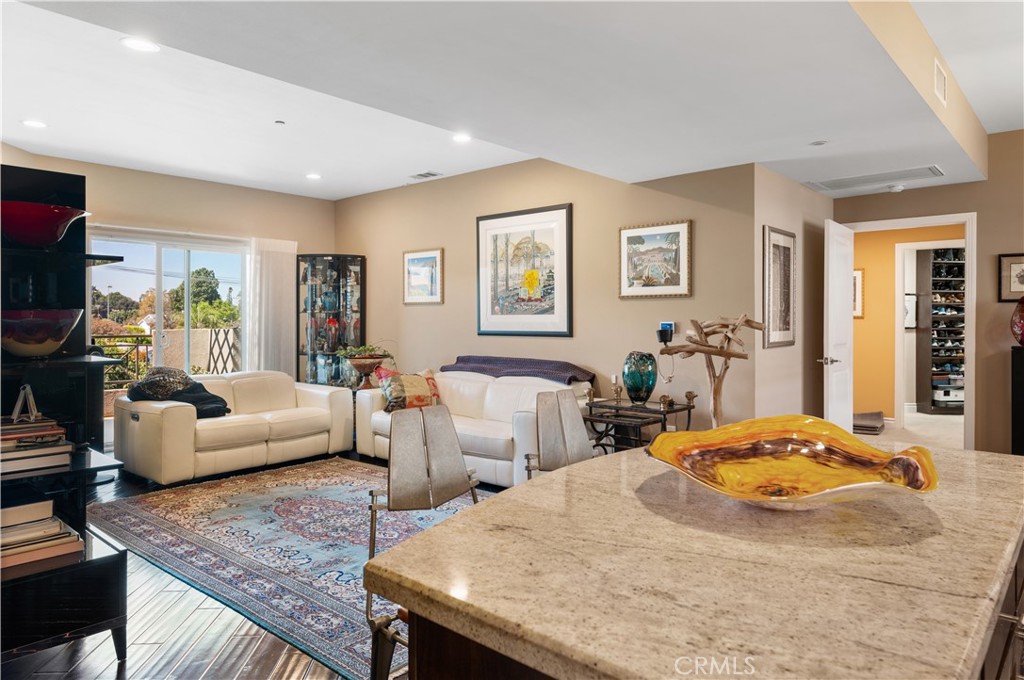 Stunning, immaculate, top floor residence in the coveted Lumiere Condominiums. A modern architecture building, a quiet oasis, yet close to everything in the heart of Studio City. One of the largest open floor plans in the building, this warm and bright home inspires a feeling of serenity and space leaving no detail behind. Morning, day, and evening light flood the unit from large windows, glass, and skylights. Modern features with timeless charm: engineered wood floors, stainless steel appliances, granite countertops, plantation shutters, new fixtures, spa-like master bath, motorized drapes, recessed LED lighting and more. This home features the highest and greatest capacity storage available in building with efficiencies throughout, including a large upgraded walk-in mainbedroom closet, custom designed pull outs, shelving, and drawers allow you to store more and live clutter free. Top of the line LG Washer/Dryer in unit. Huge main bedroom. Large second bedroom. A private terrace balcony, and an open outdoor furnished zen garden courtyard provide great places to unwind and relax in beauty at the end of a long day. Modern workout room featuring newer state-of-the art equipment and plenty of room to exercise. Secure and clean subterranean garage, with two dedicated side by side parking spaces (a premium feature vs. tandem). Security systems and features throughout the building. HOA fee includes hot water,trash service, gym usage, upgraded entry security system, underground parking, and earthquake insurance. Pride of ownership not only within the unit, but throughout the building, where the association has spent countless hours caring for the beauty and function of the building, including attention to details in the infrastructure for quality and efficiency. Newer building and healthy HOA. This is truly a spectacular one-of-a-kind home.