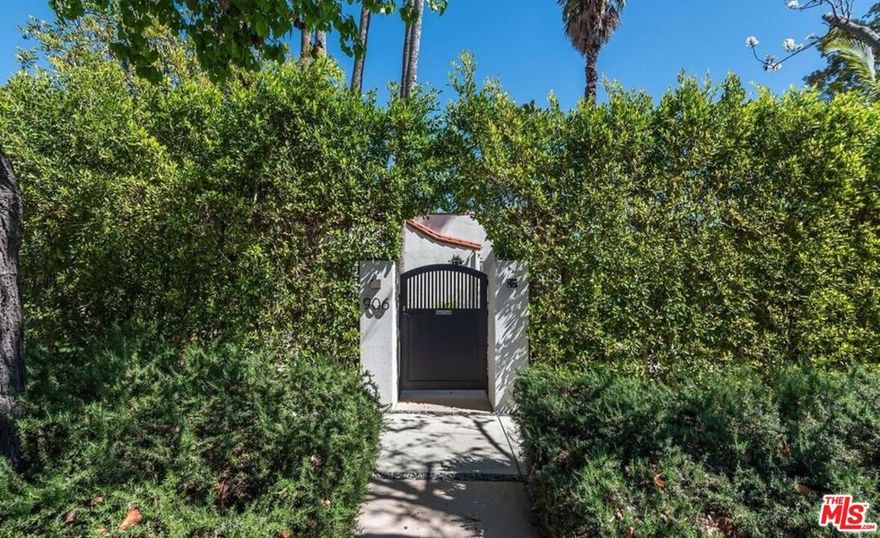 Walled and gated designer done retreat in the heart of WEHO. Surrounded by mature hedging and lush professionally landscaped and lighted yard. Formal entry with Phillip Jeffries wallpaper and Jason Koharik light fixture welcomes you to the living room with gas burning fireplace and solid oak hardwood floors. Dining room with French doors opens to the kitchen with custom walnut cabinetry, Thermador appliances, Walker Zanger Quartz counter tops and gorgeous Granada tiled floors. Separate laundry area with stackable full size washer/dryer. Primary suite with French doors overlooks the backyard with beautiful Carrera marble bathroom with separate tub and shower. Walk-in closet with built-in safe. 2nd bedroom with updated bathroom + a den with custom built-ins could also be a home office or 3rd bedroom. Backyard features a large deck and grassy yard with newly installed turf. Garage is multi-functional with built-in AC that could be a gym or home office. Located close to some of the best restaurants and shopping the city has to offer. Would make a wonderful place to call home!