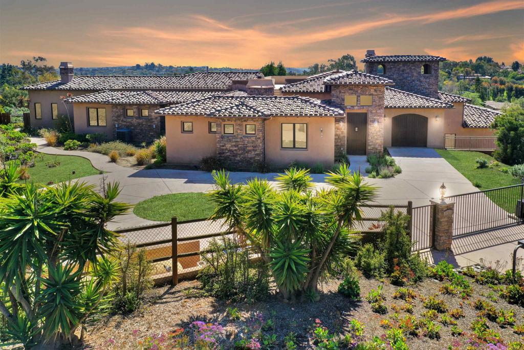 Price improvement! Come and take a look!! Welcome to 3451 Dove Hollow Road, a stunning single-family estate nestled in the serene landscapes of Encinitas, CA. This expansive home of approximately 5,630 square feet blends luxury and comfort, with every detail thoughtfully crafted to create an exceptional living experience. Step through the front door, and you’ll be greeted by an elegant 6-bedroom, 5.5-bathroom layout where custom finishes and top-tier craftsmanship are on display throughout. A welcoming portico entry leads to a courtyard with a fireplace, providing access to a private office or bedroom with a full bath, French doors opening to the courtyard, and a staircase that ascends to a rooftop deck with breathtaking views. The spacious great room features a cozy fireplace and flows seamlessly into the gourmet kitchen, a chef’s dream equipped with premium appliances—ideal for everything from quick breakfasts to elaborate dinner parties. The main-level primary suite offers a peaceful alcove overlooking the backyard, creating a tranquil retreat, while three additional bedrooms and two full baths, along with a half-bath for guests, complete the main living area. A convenient one-car garage is located on this level, offering easy access to the kitchen and main living spaces for added ease and functionality. The lower level of the home is equally impressive, featuring a private suite with a bedroom, full bath, comfortable living area with a fireplace, and a two-car garage. This level also boasts a flexible bonus room that can be used as an exercise space, craft room, or home office. The home is equipped with a multi-zone HVAC system, ensuring efficient climate control for every area of the house. For added convenience, an elevator connects both floors to the rooftop deck, providing a perfect spot for entertaining or simply taking in the panoramic views. The property is equipped with modern conveniences such as an approximately 9.1 kW owned solar PV system, city water and sewer, a gated driveway, and hard surface flooring throughout the main living areas. Nestled on an expansive lot of approximately 3.5-acres, this property may offer numerous opportunities for improvements, including space for RV parking, a sport court, or horse facilities. Buyers are encouraged to confirm the feasibility of all potential development proposals including adding an ADU or potential lot split with local authorities prior to purchase. Located just minutes from the beautiful beaches of Encinitas, top-rated golf courses, and highly acclaimed schools, this home is perfectly situated to offer both privacy and convenience. Whether you’re enjoying a stroll along the beach, perfecting your golf swing, or taking advantage of the area’s excellent schools, everything you need is within easy reach. 3451 Dove Hollow Road isn’t just a home—it’s a lifestyle. With its luxurious design, versatile living spaces, and potential for future expansion, this property is ready to become your personal sanctuary or the ultimate space for entertaining. Explore the endless opportunities and make this estate your own.