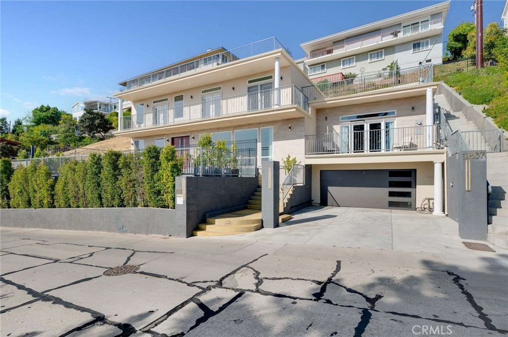 Welcome to Rideout Way, a street that offers beautiful views of the Los Angeles area nestled in a serene residential area. This newer home, built in 2022, offers modern and luxurious features. The front patio has a pool and a lounging area perfect for entertaining and soaking up the sun. Step through the double teak doorway into a world of sophistication, featuring beautiful American walnut hardwood flooring. The expansive living room boasts floor-to-ceiling windows offering expansive views. The gourmet kitchen features Dowell cabinets with a Palisandro Grigio finish, an island, quartz countertops, and top-of-the-line appliances, including a Wolf range, Thermodor hood, two sinks, and two refrigerators. There is a bar area adjacent to the living room. Step up to a secluded family room with a fireplace and a private balcony, offering even more stunning views. There is a downstairs primary suite and another bathroom for guests. Upstairs is another primary suite with a walk-in closet and two additional bedrooms, all of which have balconies and views. Tall nine-foot ceilings accentuate the open, airy feel. Some amenities include a paid-off solar system, recessed lighting, crown molding, Hunter Douglas luminette drapes, an electric car charger, and central air and heat. Two-car garage and parking. Great location with hiking in Hellman Park and Turnbull Canyon, the Uptown Farmers Market, and easy access to freeways. Longfellow Elementary School is assigned to this home.
