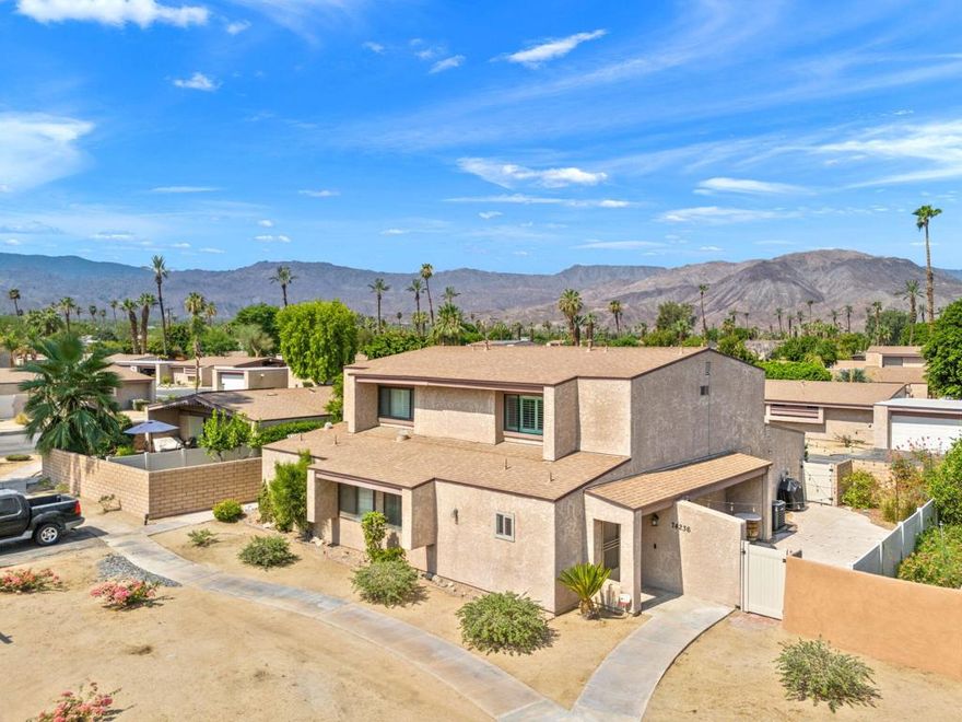 Quietly tucked at the back of gated Portola Del Sol, this light-filled end-unit townhome offers approx. 1,344 sq ft of stylish living with resort-style perks in the heart of Palm Desert. Vaulted ceilings, new LED lighting, fresh neutral paint and plantation shutters frame airy spaces and peek-a-boo mountain views. The updated kitchen features sleek Euro cabinets, quartz counters, mosaic backsplash, stainless appliances, a breakfast bar and open sight lines to the dining and living areas. Upstairs are two roomy bedrooms sharing an elegant 3/4 bath; downstairs, a flexible den/office sits beside another remodeled 3/4 bath and can function as a third bedroom or guest suite. Comfort is boosted by dual-pane windows, newer HVAC, extra storage and an attached two-car garage with laundry. Sliding doors open to an oversized, low-care patio with stamped concrete and gated side access, ideal for entertaining, grilling, pets or play. A low HOA covers cable, high-speed internet, water, trash, exterior paint, roof, plus two pools and spas, tennis, pickleball, greenbelts and guest parking. Minutes to El Paseo, Civic Center Park, McCallum Theatre, College of the Desert and top Desert Sands schools, this home is truly turn-key for full-time use, seasonal enjoyment or investment.