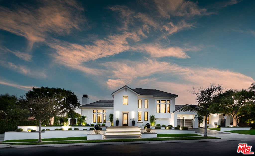 An extraordinary fusion of refined design and uncompromising craftsmanship, this fully reimagined modern estate in Calabasas sets a new standard for luxury living. Situated on a coveted view lot, this show-stopping residence has been transformed with a curated blend of bold architecture, top-tier finishes, and seamless indoor-outdoor flow offering an elevated lifestyle of sophistication and ease. Upon entry, you're greeted by expansive open living spaces adorned with brand-new designer flooring and striking iron-framed doors and windows that flood the interiors with natural light. The stunning chef's kitchen, outfitted with custom Miele built-ins, is a sleek centerpiece for both everyday living and elevated entertaining. Floor-to-ceiling pocket doors fully retract, unveiling a resort-style backyard with sweeping vistas, an infinity-edge pool, spa, baja shelf, and a covered casita with fireplace perfect for alfresco dining or relaxing beneath the stars. The primary suite is a serene sanctuary with spectacular views, two custom walk-in closets, and a spa-inspired bathroom that features radiant heated floors, floor-to-ceiling mirrors, ambient lighting, and an oversized steam shower for ultimate relaxation. A state-of-the-art home theater with immersive 8K projection delivers a cinematic experience beyond compare, while a full-property Sonos audio system, indoor and outdoor TVs, and new amplifiers provide entertainment throughout. Every detail of this estate has been elevated with thoughtful upgrades. The exterior has been transformed with new landscaping and landscape lighting in both the front and back, along with newly installed water fountains and tranquil features that enhance the ambiance. The entire home has been freshly painted inside and out, and the newly refinished driveway and courtyard now showcase custom tile and elegant hardscape design. Additional highlights include a brand-new soft water and saltwater filtration system, new pool equipment, and an advanced surveillance camera system with alarm integration for top-level security. The spacious garage has also been upgraded with new custom doors, high-end epoxy flooring, and built-in cabinetry for exceptional storage and style.This is a rare opportunity to own a one-of-a-kind modern estate in one of Calabasas' most sought-after communities where bold design meets effortless elegance, and every element has been masterfully executed for the most discerning buyer.