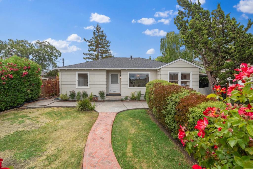 Perched atop a sunsoaked hill, this thoughtfully updated home sits on a nearly flat 1/3 acre of land with Bay views from nearly every corner. A bountiful, mature orchard provides fresh fruit throughout the seasons and provides a backdrop for al fresco dinners, kids' adventures, or simply tending to your green thumb. Further development of the expansive land may be possible, including incorporating a second structure within the orchard, adding a pool, or anything else one could imagine. Inside, gleaming hardwood floors flow throughout the living space, and plenty of sunlight fills nearly every room. A rare configuration of the home adds flexibility and privacy - the attached fourth bedroom and second bath has its own entrance, making it ideal for a guest suite or home office. Perfectly located close to everything with easy access to commute routes, San Francisco, or anywhere in Silicon Valley.