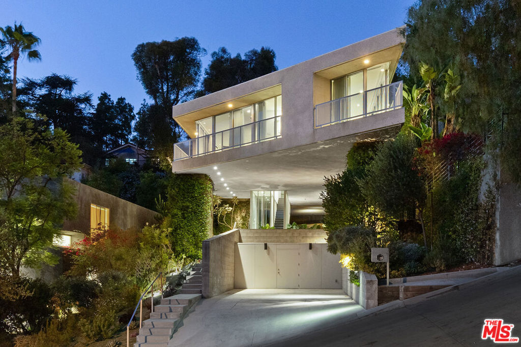 House on Six Legs by Escher GuneWardena Architecture. A stunning Silverlake architectural residence designed by the internationally renowned firm Escher GuneWardena - board members of the John Lautner Foundation and featured on Dwell's prestigious Home Tour. Evoking the spirit of Lautner, this meticulously crafted home offers a refined, modernist living experience just moments from the Silver Lake Reservoir. Enter through a dramatic floating stair atrium into a completely linear, open-plan living space flooded with natural light from expansive southern and western exposures. The chef's kitchen features an oversized island and walls of cleverly integrated pantry storage, flowing seamlessly into a living and dining area wrapped in sliding glass. The primary suite offers a retractable wall that frames sunset views, along with a generous walk-in closet and a spa-inspired bath. Two additional bedrooms share a well-appointed bathroom with skylights, while a fourth bedroom doubles as a flexible office/guest space with a built-in foldaway bed and custom work area. The professionally landscaped outdoor areas planted with citrus trees and California natives connect effortlessly to the home and include an elevated lounge, dining area, built-in BBQ, and multiple seating areas for entertaining. All living and entertaining spaces are thoughtfully designed on a single level, combining sophisticated architecture with luxury living comfort in this accessible and coveted Silverlake location. 4 car parking on the property and additional storage room below. Moments to the reservoir, dog park, Sunset Junction and many of the areas best shops and restaurants.