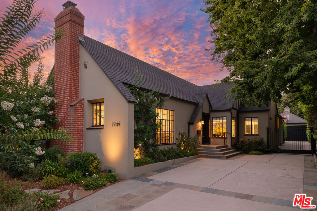 Established on a picturesque Jacaranda-lined street in Pasadena, this beautifully remodeled English-style home seamlessly blends timeless architecture with modern comfort. With four bedrooms and three baths, the residence offers a gracious floor plan ideal for both everyday living and entertaining.The formal living room, with its beamed ceilings and original steel casement windows, is rich in character and charm. The elegant formal dining room is ideal for entertaining and opens conveniently into the butler's pantry, which adds function and style. The well-appointed kitchen flows seamlessly into the spacious family room, with a convenient wet bar and wine fridge. The primary suite is a true retreat, featuring a walk-in closet, a luxurious en suite bath, and sliding doors that open to the backyard deck.Outdoors, the landscaped grounds are truly spectacular, designed for entertaining and relaxation alike, with an outdoor kitchen (grill and sink), deck, tranquil fountains, and raised planter beds. The finished attic offers an excellent bonus space, and an additional versatile bonus room is located just off the two-car garage.This enchanting residence combines historic charm with thoughtful updates, creating a Pasadena home that is as functional as it is beautiful.