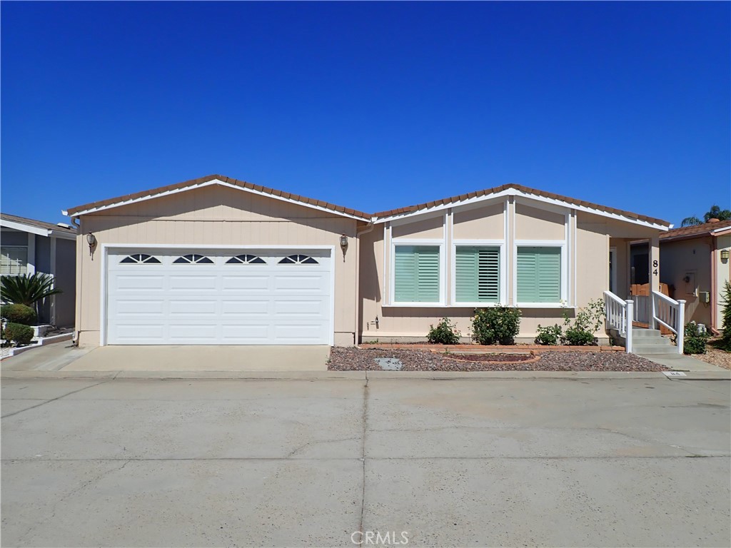 This beautifully maintained 2 bedroom 2 bath home is located in the 55+ Community of Sun Meadows. This spacious home boasts over 1800 square feet of open living space. Beautiful hardwood and stone tile flooring throughout! Enter into the home into a huge living room with vaulted ceilings. Open to the remodeled gourmet kitchen with counter seating, and large formal dining room. In addition are 2 very spacious bedrooms, 2 full bathrooms and large indoor laundry room. A large covered patio with bedroom access or dining room access complete this gorgeous home. This is one of a kind in the park and across the street from the clubhouse and all park amenities! Must see to appreciate.