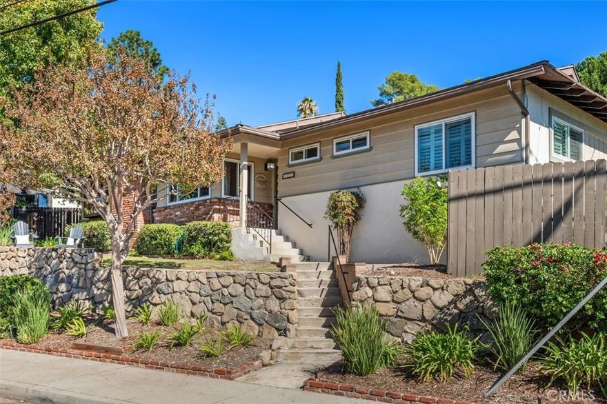 Welcome to this bright and inviting single-level home, perfectly situated in the highly sought after Crescenta Highlands neighborhood.
This charming 3 bedroom, 2 bath residence sits gracefully above the street, offering peaceful treetop and mountain views. Inside, the cozy living room features a classic fireplace, recessed LED lighting, and dual-pane windows that fill the space with natural light. The kitchen includes a lovely bay window overlooking the trees and mountains, providing a serene backdrop while you cook or enjoy your morning coffee. A warm and welcoming family room centers around a charming wood-burning stove set against a brick surround, creating the perfect spot to gather on cooler evenings. Modern comforts include central heating and air conditioning with a smart Nest thermostat, plus a tankless water heater for energy efficiency and endless hot water. Step outside to a private backyard retreat, ideal for relaxing or entertaining, featuring a comfortable patio sitting area surrounded by mature fruit trees that add both beauty and function to the space. Additional highlights include a detached 2 car garage with a convenient laundry area and access to award-winning local schools. Enjoy being just minutes from parks, scenic hiking trails, charming cafés, and some of the area’s best restaurants.