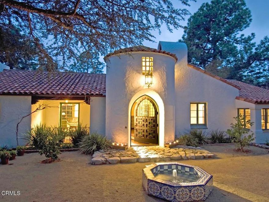Designed in 1925 by renowned architect Arthur Rolland Kelly as his personal residence, this gracious Spanish Hacienda has been thoughtfully expanded and restored by Michael Burch Architects. Featuring hand-carved beams and intricate stenciling by noted artist Anthony B. Heinsbergen, the home is proudly listed on La Canada's historic property registry.Set behind gates, the property welcomes you with a decomposed gravel motor court and fountain. Inside, a grand entry opens to the formal living room with fireplace and a formal dining room, where French doors lead to a wisteria-draped terrace overlooking the lap pool and spa.The chef's kitchen is outfitted with premium appliances, including a 48' Sub-Zero refrigerator, Thermador Professional Range, Miele dishwasher, and built-in microwave. The residence offers four bedroom suites, including a primary suite with dual bathrooms, as well as a private study with fireplace. A library with its own entrance off the driveway makes an ideal home office.Upstairs, a spacious loft with powder room offers flexibility for an additional office or guest room. The lower level includes a media/playroom with fireplace that can double as a bedroom suite, as well as a separate bedroom with its own entrance.Three terraces showcase sweeping canyon views framed by downtown Los Angeles and Catalina Island in the distance. Nestled in La Canada's Upper Deodar neighborhood, the property is within walking distance of the award-winning Palm Crest Elementary School, and minutes from freeway access, Old Town Pasadena, Downtown LA, and the Burbank Studios. Additional features include 5-zone central air, high-speed internet, and a security system.