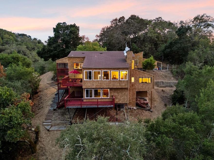Welcome to 9040 El Matador Dr. A serene 3-acre retreat at the end of a quiet cul-de-sac in Gilroy, surrounded by nature's beauty and peaceful stillness. With panoramic views from nearly every room and five expansive decks, this home invites seamless indoor-outdoor living. Warm hardwood floors, granite slab countertops, and two fireplaces add charm inside, while the primary suite offers a jetted tub with stunning views perfect for quiet moments of relaxation. Thoughtfully designed to blend with the landscape, the property features a welcoming stone entry, an oversized 2+ car detached garage with a workshop and storage loft accessible with stairs, and expansive wooded grounds including a private shooting range. Just minutes from town yet feeling worlds away, this one-of-a-kind property offers unmatched privacy, natural beauty, and the best of peaceful country living.