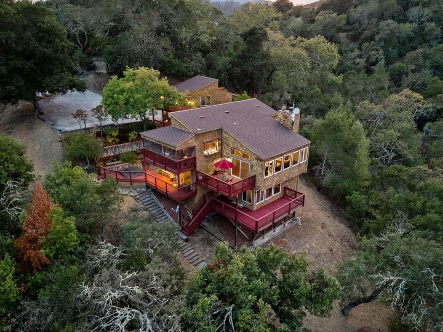 Welcome to 9040 El Matador Dr. A serene 3-acre retreat at the end of a quiet cul-de-sac in Gilroy, surrounded by nature's beauty and peaceful stillness. With panoramic views from nearly every room and five expansive decks, this home invites seamless indoor-outdoor living. Warm hardwood floors, granite slab countertops, and two fireplaces add charm inside, while the primary suite offers a jetted tub with stunning views perfect for quiet moments of relaxation. Thoughtfully designed to blend with the landscape, the property features a welcoming stone entry, an oversized 2+ car detached garage with a workshop and storage loft accessible with stairs, and expansive wooded grounds including a private shooting range. Just minutes from town yet feeling worlds away, this one-of-a-kind property offers unmatched privacy, natural beauty, and the best of peaceful country living.