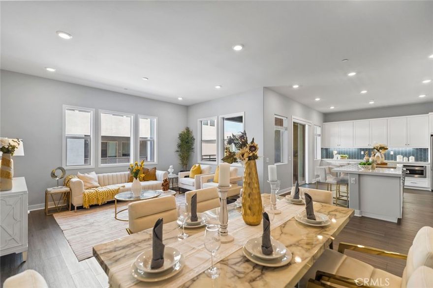 Price reduced by 30K !!! Built in 2023, this contemporary 4-bedroom, 3.5-bath condominium is set within a desirable guard-gated community featuring a luxury clubhouse. The open floor plan showcases a spacious great room, dining area, and chef’s kitchen with quartz countertops, custom backsplash, stainless steel appliances, a large center island, and a walk-in pantry—perfect for everyday living and entertaining. From the kitchen, two sliding doors open to a generous balcony, creating an inviting outdoor space where you can sit back and relax.

The first floor includes a private bedroom with its own full bathroom, ideal for in-laws, guests, or rental use. Upstairs, the primary suite offers a comfortable layout with dual vanities and a walk-in closet, while the additional bedrooms provide versatility for family or home office needs.

Other highlights include recessed lighting, a washer and dryer, direct-access 2-car garage, and premium finishes throughout. A private rooftop deck expands the outdoor living experience—perfect for barbecues, gatherings, or enjoying city fireworks.

Conveniently located near Costco, Asian markets, a variety of restaurants, Montebello Mall, and with easy freeway access to Downtown LA, this home combines modern design, comfort, and secure luxury living.