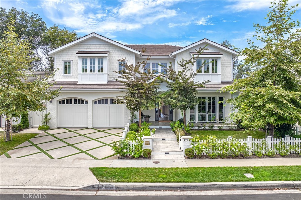 1707 Newport Hills Dr was completely rebuilt to the studs in 2023 with no expense spared. Designed with top-of-the-line finishes, high-end systems, and exquisite millwork, this home defines aspirational living. Custom woodworking, a stunning staircase, and herringbone wood floors warm and elevate the interiors. Just off the foyer, a moody lounge sets the stage for cocktails, game nights, or intimate gatherings. The expansive great room features a tufted leather banquette, custom buffet, and oversized trifold doors that blur indoor/outdoor living. The showpiece kitchen boasts striking porcelain countertops, a La Cornue 6-burner oven and range, oversized island with breakfast bar, and thoughtful details including exposed brick, timeless tilework, brushed brass hardware, and custom drying racks. A butler’s pantry and back kitchen offer double ovens, a coffee bar, full-size refrigerator/freezer, and extensive storage. The first level also includes an oversized mudroom, full bath, and versatile bonus room. Upstairs, four spacious bedrooms each feature ensuite baths, walk-in closets, and automated window coverings. The primary retreat offers bay-window banquette seating, a Calacatta Gold marble bath with soaking tub, dual vanities, heated floors, and oversized walk-in closet. A large loft captures sunset views over Harbor View Nature Park and overlooks the pool. A beautifully designed laundry room with dual washer/dryers, steamer console, and cabinetry completes the second story. The backyard is an entertainer’s dream with 430 sq. ft. of covered living space, full outdoor dining and lounge with fireplace, saltwater pool and spa, outdoor TV and speakers, and raised sundeck—all framed by serene park views. Blending timeless European elegance with modern California coastal living, 1707 Newport Hills Dr is more than a home—it’s a lifestyle.