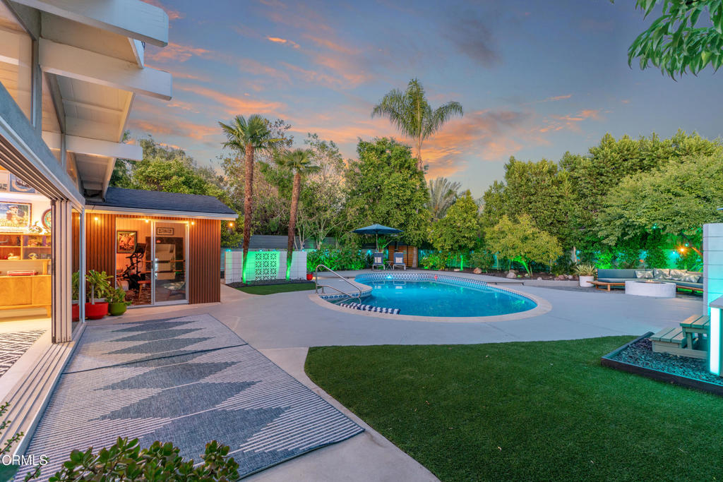 Modern Luxury Home with Palm Springs Vibes & Resort Style Backyard. This stunning North Hollywood retreat captures the essence of modern California living. A turnkey private oasis thoughtfully curated and fully updated in mid-2023. Crisp architectural lines, designer finishes, and effortless indoor-outdoor flow create a true resort feel. The open interior showcases expansive Grafton Silver porcelain tile floors, custom plantation shutters, smart dimmable lighting, and a dramatic four-panel sliding glass door leading to a private backyard oasis. The sleek chef's kitchen features Caesarstone countertops, dark grey Voxtorp cabinetry, and a full suite of Samsung appliances including a double wall oven, cooktop, and French door refrigerator with changeable glass panels. Luxurious bathrooms have been completely remodeled and blend high design with technology with the hall bath featuring Beverly Hills Hotel style wallpaper, Italian tile, steam shower, double vanity sink and mirrors. The backyard is an entertainer's paradise and enjoy your personal resort with a resurfaced black pebble pool, Hot Springs salt spa, smart landscape lighting, and multiple mature fruit trees. Additional features include: Bonus room/gym, newer roof, HVAC and ducting, tankless water heater, Vivint security with cameras, Tesla Solar, rebuilt garage with storage, and Flume water monitoring. A rare modern sanctuary combining luxury, comfort, and smart-home living. Perfect for those who love style and sunshine.