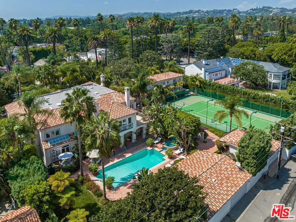 An extremely rare "double lot" on nearly 1 acre on one of the best blocks in the Flats of Beverly Hills. As rare as an opportunity as it gets to acquire an extraordinary and very sought after property, includes two side-by-side separate properties (812 & 814 Bedford). The Mediterranean style main house features just under 10,000 sf with 6 bedrooms, high ceilings, a grand two-story entry, large living room, library, family room, gourmet kitchen, spectacular primary suite with sitting room and two baths in closets. Great volume throughout, designed by an internationally acclaimed designer. Additional features include a 2 story, 5 bedroom guest house, a championship tennis court, and a beautiful pool with adjacent pool house/cabana/guest house. All behind gates in one of Beverly Hills' best and most walkable locations. Shown to pre-qualified clients only.