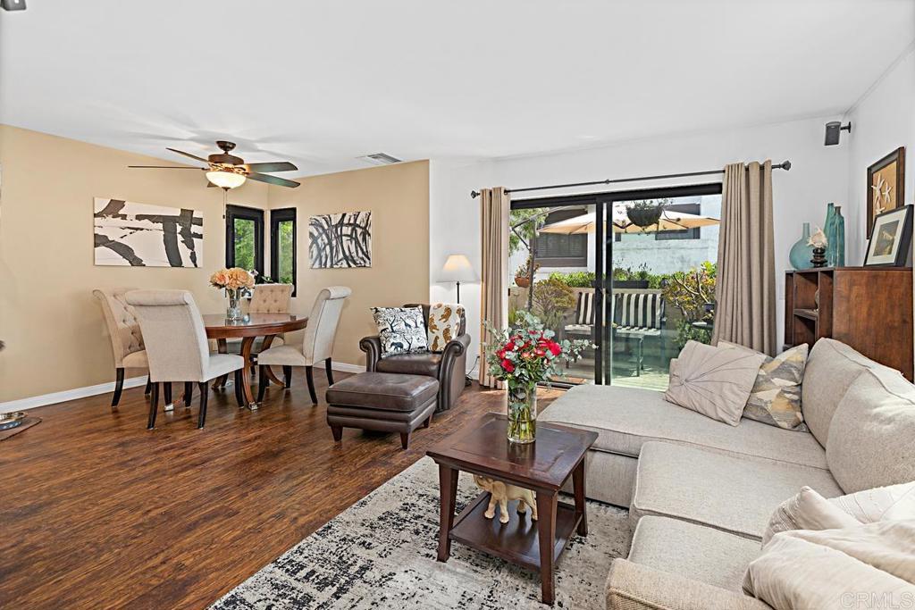 Welcome to your future home! This charming end-unit townhouse invites you to enjoy a cozy lifestyle in a bustling neighborhood. Spanning 1,074 square feet, this thoughtfully designed home includes two bedrooms and one and a half bathrooms, providing ample space for relaxation and privacy. The open-concept living area is bathed in natural light and showcases beautiful updated vinyl plank flooring, making it perfect for entertaining or everyday living. The kitchen, seamlessly connected to the dining and living areas, is great for gatherings and features Caesarstone Quartz countertops, stainless steel appliances, and a striking full-height mosaic backsplash. The bathrooms are upgraded with elegant quartzite countertops and brand-new fixtures. Step out to your private patio, a perfect spot for morning coffee or winding down in the evening. Comfort and convenience are prioritized with central air conditioning ensuring a pleasant environment year-round. The home also includes newer windows and an in-unit washer and dryer to make laundry easy. For parking, the attached garage offers security and extra storage space. The community amenities enhance your living experience with a sparkling pool for refreshing swims, basketball and tennis courts for friendly matches, and a playground for the little ones. Plus, you're just minutes away from the beach and Liberty Station, making this location ideal. Seize the opportunity to make this charming townhouse your new home!