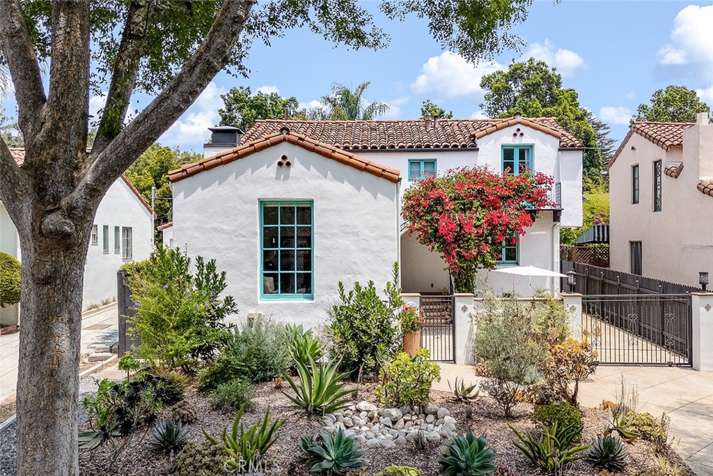 Discover this exquisite Spanish-style residence nestled in Pasadena’s coveted San Rafael neighborhood. Tucked away on an idyllic, tree-lined street, this two-story gem offers the perfect harmony of privacy, elegance, and convenience—just moments from downtown Los Angeles and Pasadena’s vibrant core.
Recently updated with meticulous attention to detail, this home boasts a host of modern upgrades, including a new dual-zone HVAC system, a chef’s kitchen featuring all new appliances—such as a 48" gas Wolf stove, 42" Sub Zero refrigerator, and custom pantry shelving. The interior has been refreshed with new paint, refinished wood flooring, new Saltillo floor tile, and updated bathrooms. Additional enhancements include a new on-demand tankless water heater and custom built-in cabinets in the library, providing both style and functionality.
The spacious layout comprises three bedrooms and two bathrooms. The downstairs bedroom and bath offer convenience, while the upstairs features two large bedrooms and a beautifully remodeled bathroom. The primary bedroom is a true retreat, with a Juliette balcony, two professionally designed walk-in closets—including a cedar-lined wardrobe—and an additional room sized walk-in closet in the hallway, all crafted to showcase and organize an impressive wardrobe.
Throughout the home, large arched doorways and casement windows flood the space with natural light, complemented by new recessed lighting, designer fixtures, and elegant chandeliers. The home’s decor is tastefully curated, creating a warm and inviting atmosphere.
Enter through a private, enclosed courtyard and pause to enjoy the soothing water feature. The front door is flanked by a profusely blooming bougainvillea noted by neighbors as a stunning showpiece. The grand foyer welcomes you with an impressive light fixture and a wrought iron staircase, recently installed. The foyer leads to the living room with soaring 13-foot vaulted ceilings, a striking decorative fireplace, and a large picture window framing views of the neighborhood. The formal dining room, library, and chef’s kitchen—with a picture window overlooking the private lush backyard—complete this exceptional home.
This home is turnkey and ready for you to move in and enjoy. A full list of improvements is available. Experience timeless elegance in this remarkable residence.