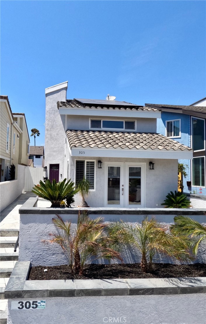Welcome to 305 21st Street, an exquisite residence in the heart of Huntington Beach, just a block away from the famed Huntington Beach. This brand new remodeled haven offers three spacious bedrooms and two and a half bathrooms within a sprawling 2,400 square feet with 2 living rooms. Step inside to discover a newly remodeled kitchen and bathrooms, showcasing contemporary finishes that blend style with functionality. The open-concept layout is adorned with new floors throughout, creating a seamless flow from the living spaces to the private back patio, perfect for intimate gatherings or tranquil moments. The home features high ceilings architecture and skylights, inviting an abundance of natural light to illuminate the interiors and a NEW roof. Enjoy the luxury of air conditioning and a convenient washer/dryer upstairs and PAID solar! The detached garage provides ample parking and storage space. Outside, the front patio offers an ocean view, while the back yard serves as a peaceful retreat. Positioned in a coveted location near the beach, this home embodies coastal elegance and modern comfort. Don't miss out on this!