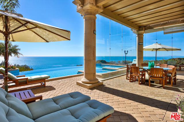 Superbly crafted, custom designed 2-story ocean view estate w/detached guest room on apx. 5 acres. Double gated/private, this 7 bedroom/12 bath home w/elevator offers a large columned circular portico leading to an ocean view entry & formal living room w/fireplace, bar & high ceilings that is open to a formal ocean view dining rm. Huge ocean view gourmet kitchen & family/media room w/dining area. Beautiful ocean view owner's suite w/hand scraped walnut floors, fireplace, sitting area, private deck, 2 vast closets & double spa-like baths separated by large spa shower. 2nd ocean view owner's suite w/fireplace has a private deck & spa-like bath. Custom designed projection home theater. Lush, manicured grounds, mature trees & fruit orchards w/full kitchen that's steps from an ocean view infinity pool/spa & large glass enclosed dining area. 3-car garage w/additional covered porte-cochere for 8-cars & ample guest parking. Standby 130 KW Generac generator for entire house & outside amenities.