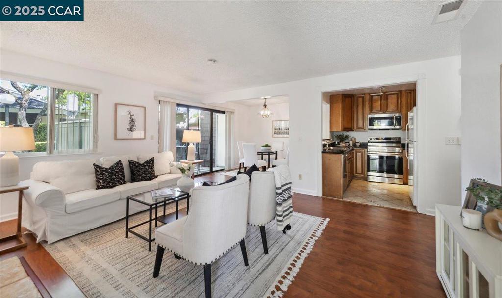 This wonderfully maintained single level, first floor, corner unit condo seamlessly combines style, comfort, and convenience. Inside, you'll find many upgrades that elevate everyday living. The open-concept living area connects to a sleek kitchen featuring newer Bosch and Samsung appliances, stone countertops, and abundant cabinetry—perfect for both relaxing at home and hosting guests. Additional features include two elegantly remodeled bathrooms, an in-unit laundry room with built-in storage, a charming wood burning stone fireplace, energy-efficient dual-pane windows and two close and dedicated covered parking spaces. Step out onto your private balcony to unwind amidst the natural beauty of towering redwood trees to keep you cool—your own peaceful retreat. Close to the refreshing pool, guest parking and ideally located just minutes from shopping, dining, parks, public transit, and major freeways. This home offers a low-maintenance lifestyle in a prime location. Whether you're a first-time buyer, downsizing, or seeking a smart investment, this property is a must-see!!!