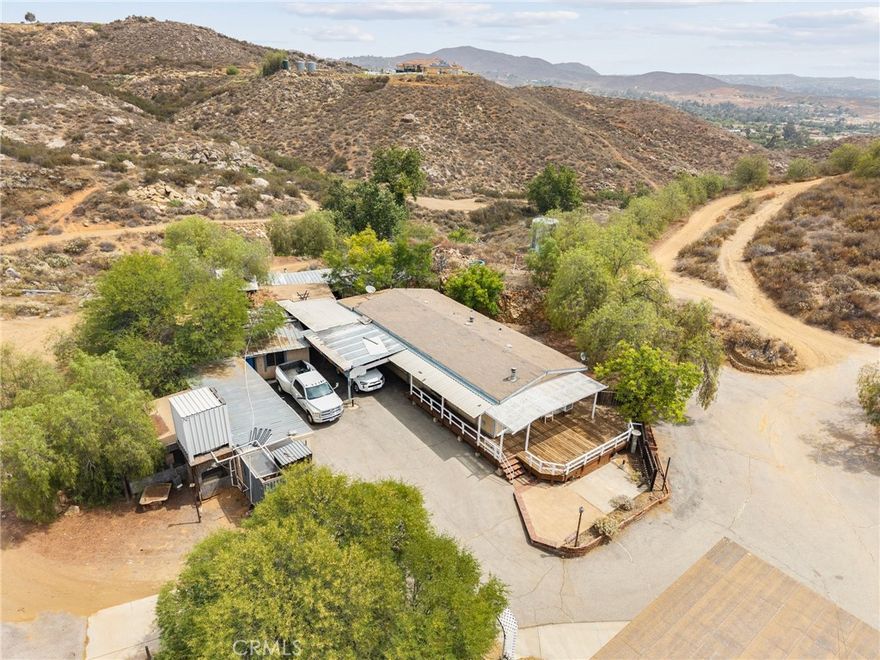 If you're searching for land with an existing home and multiple amenities, this property is a must-see! It offers a scenic main pad with incredible views to build your dream home, an additional pad perfect for an ADU, and a dedicated RV parking area with full hookups for family and friends. Plus, there's extra covered RV parking, a spacious recreation area for family fun, and a versatile workshop for your projects. Don't forget about the functioning water well with a brand new motor is on property with a 7,500g storage tank. Words, videos, or images can't do this property justice—it's truly something you need to experience in person. Contact me today to schedule your private tour!