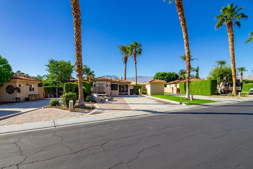 Located along Motorcoach Country Club's quiet south wall, Lot 264 offers the perfect blend of privacy, comfort, and functionality. Backing up to a residential neighborhood rather than a major road, this lot provides a peaceful setting without the distraction of traffic noise.The front of the lot features an expanded paver patio with dedicated golf cart parking and charging, plus a large rectangular fire pit with ample seating--ideal for gathering with friends and enjoying the desert evenings. The private backyard offers a spool with a soothing waterfall feature, BBQ island, additional water feature, and synthetic turf area perfect for pets. A large retractable awning extends over the backyard for added shade, creating a comfortable outdoor retreat that can be enjoyed year-round.The attached casita includes a 3/4 bathroom with a full tile shower, generous cabinetry for storage, and its own mini-split system for climate control--perfect for guests or a private workspace. Inside the coach house/tile-roof shade structure, you'll find a full kitchen with dine-in seating, an island with bar seating for up to six, and a cozy living area with fireplace, TV, and comfortable seating. The space is fully enclosed with CoverGlass stacking glass panels, allowing for a seamless indoor/outdoor flow that captures the essence of desert living.Motorcoach Country Club offers resort-style amenities including a private golf course, three pools and spas, pickleball and tennis courts, a fitness center, and a newly renovated clubhouse with on-site restaurant and bar. Scenic canals offer opportunities for boating and paddleboarding, and a vibrant social calendar keeps residents engaged all season long.Motorcoach Country Club exclusively accommodates Class A motorhomes from 30' to 45'. Due to zoning, on-site properties are not considered dwellings, and overnight stays inside them are not allowed. MCC's annual Food & Beverage minimum is $2,080.