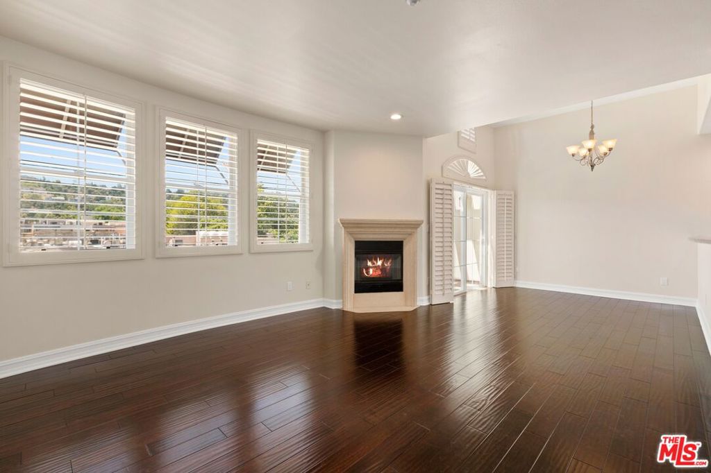 This stunning penthouse condo has 3 bedrooms, 3 bathrooms including 2 ensuite baths, and a large den/office with built-ins and French doors. The kitchen is well appointed with stainless-steel appliances and opens to an airy living room complete with a fireplace and dining area that flows out to a balcony with views of the mountains. The unit has high ceilings and large windows throughout which flood the space with natural light and frame spectacular views from every room. Generous storage, with high-quality built-ins, ample closets, two large walk-in closets, and a dedicated laundry closet housing a new washer and dryer, plus additional storage. The building itself is meticulously maintained, surrounded by lush greenery, and features a charming central atrium with a bubbling fountain. Residents can also unwind on the community rooftop deck, which offers lounge chairs and views of the city and mountains. The building sits in a picturesque residential enclave of Studio City close to the vibrant Studio City Village, filled with shops and restaurants.