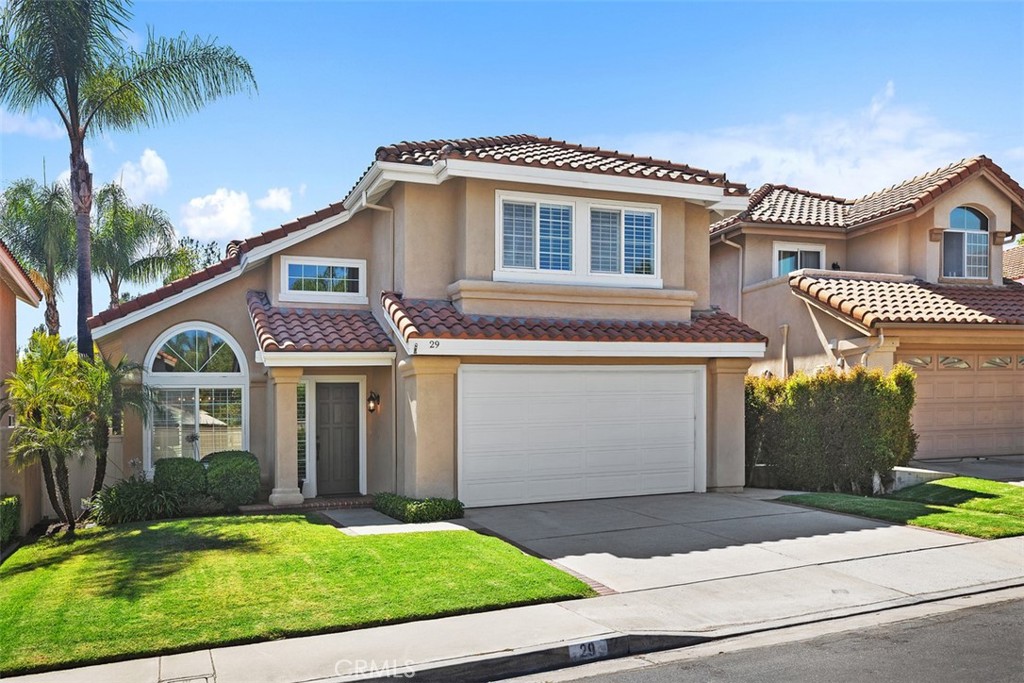 Welcome to 29 Raposa, located in the heart of Rancho Santa Margarita, consistently ranked one of California’s safest cities! This beautifully updated 4-bedroom home offers the largest floor plan in the neighborhood with 1,977 sq ft of living space and RE-PIPED with Pex piping! Step inside to a light and bright living room with soaring ceilings that create an open and airy feel. The entire home has been freshly painted throughout with an updated color palette and features new carpet in the living/dining area, and primary bedroom, and newer luxury vinyl flooring in the entry, upstairs hall and bedrooms. The newly refreshed kitchen will impress with white cabinetry, brushed nickel hardware, brand-new stainless steel appliances and faucet, and a cozy eat-in nook with oversized windows to take in the views of the spacious backyard and the treetops of Oniel Park, which is just a stones throw away…and no neighbors behind! The family room features a sleek white brick fireplace and French doors that open to the backyard, which is shaded by a freshly painted patio cover, perfect for outdoor relaxing and entertaining. Downstairs also includes a beautifully updated powder room, a convenient indoor laundry room, and direct access to a 2-car garage with plenty of built-in storage. Upstairs, the primary suite offers a peaceful retreat with high ceilings, remodeled ensuite bath with huge walk-in shower, dual sink vanity, a second spacious closet area with mirrored doors, and flooded with natural light. Three additional bedrooms share an updated full bath with dual sinks, tub/shower combo, and new fixtures and faucets. Additional highlights throughout the home include plantation shutters throughout, dual-pane windows, new HVAC system (2 years), closet organizers in all bedrooms, ceiling fans in 3 bedrooms, and new fencing in backyard. Enjoy low HOA dues with full access to Rancho Santa Margarita’s incredible amenities: Beach Club Lagoon at RSM Lake with snack bar, volleyball, and water toy rentals, 4 Junior Olympic size pools,12 parks, new splash pad, pickleball & sport courts, trails around O’Neill Park which is just around the corner, summer movies in the park and live bands at the lake, walkable to shops, restaurants, and community events! Don’t miss this opportunity to own a home in the vibrant RSM Lake community!