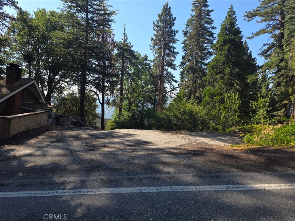 Great Location!! Surrounded by majestic mountain pines and breathtaking views, this 8,400 sq ft lot in Running Springs, CA offers a rare chance to build your dream home in one of Southern California’s most peaceful and scenic mountain communities. The lot is builder-ready—a water meter is already installed, and the sewer lateral is in place, saving you thousands in utility hookups and impact fees. A home once stood here, and the concrete driveway area and retaining wall are still in place, giving you a valuable head start on construction. Located on Live Oak Drive, a county-maintained, two-sided road, the property offers year-round access with the convenience of nearby shops, dining, and outdoor recreation. Priced at only $99,000, this is not just a beautiful piece of land—it’s a smart investment in your future.