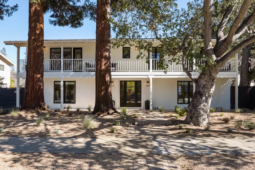 A turn-key home on a beautiful tree lined street in the heart of Professorville. Broad balconies wrap the exterior of this beautifully renovated home. The main level includes a formal living room with a fireplace and french doors that lead out to a lovely pool and deck area. A separate dining room and family room, a sunny kitchen w/ breakfast nook, plus an office or fifth bedroom complete the first level. The second level offers four large bedrooms each with separate balcony access, three full bathrooms and a laundry area. The garage has been beautifully converted to lovely living space with a bathroom and large closet, perfect to add a kitchenette for an ADU. A solar heated swimming pool with a hot tub and an outdoor shower create a true entertainer's paradise. Just blocks to Town and Country Village, Stanford University, Walter Hays Elementary school, Gamble garden and the University avenue shops and restaurants.