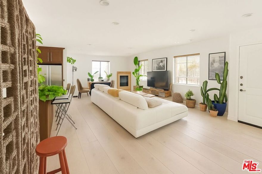 Welcome to an elegant and expansive 3 bedroom, 2 bathroom residence in the heart of West Hollywood offering nearly 2,000 square feet of refined living space. Perfectly situated on the third floor of a well-maintained building near La Cienega and Santa Monica Boulevard, this unit combines the spacious feel of a private home with the convenience of luxury condo living. Step inside to a bright and open floor plan featuring rich floors, recessed lighting, and abundant natural light throughout. The generous living and dining area opens to a private balcony creating the ideal setting for entertaining or unwinding. The kitchen is a chef's dream complete with a large center island, granite countertops, and stainless steel appliances including a gas stove, refrigerator, dishwasher, and built-in microwave. The oversized primary suite includes a spacious en suite bathroom with double sinks and ample closet space, while two additional bedrooms offer flexibility for guests, a home office, or family living. A full-sized washer and dryer in unit adds to the convenience. This residence also includes a private balcony and access to a beautifully maintained communal rooftop deck with stunning views. A community jacuzzi on the main level offers a tranquil space to relax and recharge.Additional features include two secured parking spaces in a gated garage and controlled access to the building.Enjoy unbeatable walkability with West Hollywood's most iconic spots just steps away. Barneys Beanery, Soho House Holloway, and countless cafes, restaurants, and nightlife destinations are all within a short stroll.This unit is offered unfurnished.