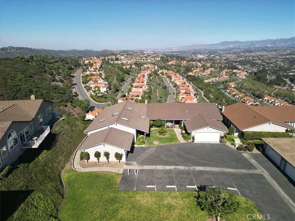 Perched high in the hills of Laguna Niguel, this beautifully updated 2 bedroom, 2 bath single-level home offers sweeping, unobstructed views stretching across the valley to the Saddleback Mountains. Nestled in the sought-after Monarch Summit community within Pacific Island Village III, this residence combines modern upgrades with timeless coastal charm. From the moment you arrive, a secluded, private entry sets the tone for the serene lifestyle this home provides.
The gourmet kitchen boasts stainless steel appliances, a new cooktop, granite countertops, white cabinetry, and a walk-in pantry with interior laundry. New wood-like plank flooring throughout creates a warm, modern feel, while automatic exterior shades and dual-pane windows maximize comfort and energy efficiency. A tankless water heater adds further convenience.
Abundant natural light streams through three skylights, highlighting the spacious interiors with vaulted beam ceilings and an inviting fireplace. Step outside onto the expansive deck—perfect for relaxing or entertaining against a breathtaking backdrop of endless views.
Additional highlights include a 2-car attached garage, guest parking just steps away, and resort-style amenities: pool, spa, and clubhouse. Ideally located just minutes from world-class beaches, dining, shopping, hiking trails, and golf courses, this home captures the very best of Southern California living.