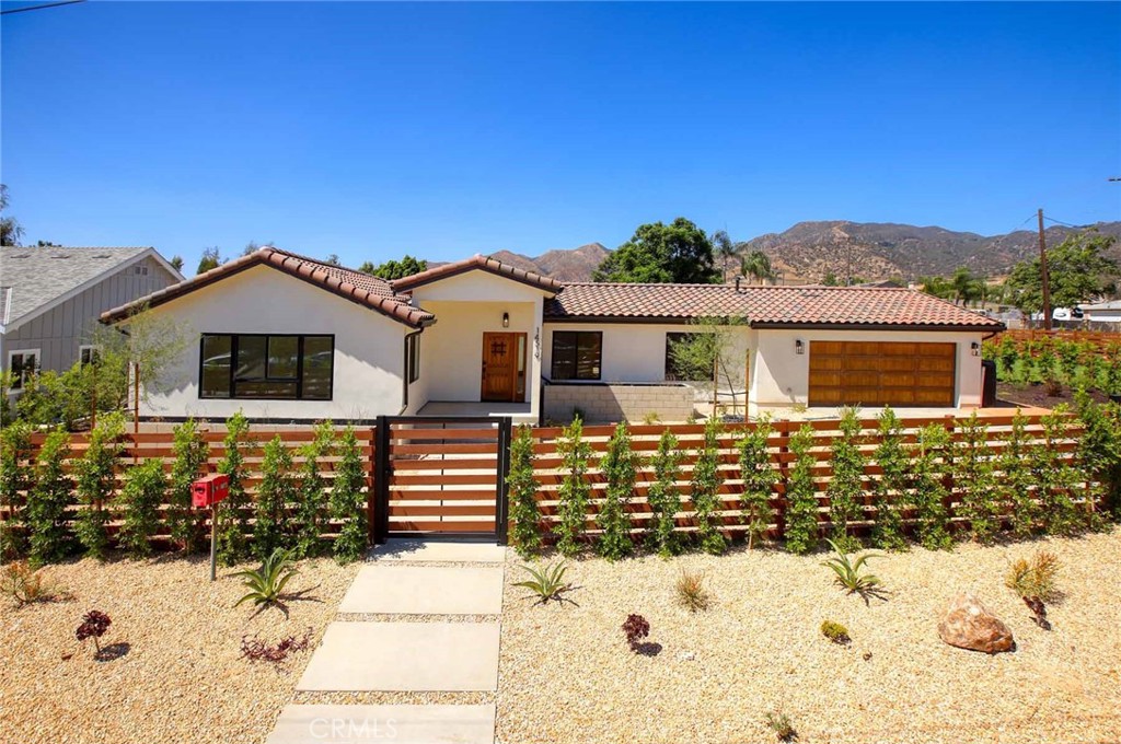 Welcome to a beautifully designed new construction estate offering both luxury and versatility. The main residence features open floor plan that wraps around to a stunning courtyard, three spacious bedrooms, a versatile bonus room, and two and a half elegant bathrooms. Step into the chef’s dream kitchen, fully equipped with WiFi-enabled Jenn-Air appliances, including a 36" professional 6-burner range top, 30" wall oven, 42" paneled French-door refrigerator/freezer, under-counter glass door fridge, and a custom-panel dishwasher. The design is elevated with porcelain countertops, a Calacatta Oro island with prep sink, farmhouse sink, brushed gold Pfister fixtures, and gold cabinet hardware. The open living room boasts gorgeous hardwood floors that continue throughout the home, picturesque windows, high ceilings with recessed lighting, and the dining has elegant chandelier lighting. A spacious bonus room includes a cozy study nook—perfect for working from home. The luxurious primary suite with slider to the serene courtyard and the primary bathroom offers an 84" double vanity, a freestanding 65" soaking tub, a rain head shower with gold finishes, and a large walk-in closet with built-in organization. A stone-paved courtyard with a gas fireplace invites year-round outdoor relaxation. Additional highlights include fire sprinklers, central AC & heat, a 2-car garage with laundry area, fully gated and a private enormous beautifully landscaped yard. The detached ADU , with its own address, is approx. 1,300 sq ft, featuring 3 bedrooms, 2 bathrooms, and its own gated yard and entry. Ideal for multi-gen living or rental income, it showcases a full LG smart appliance package: a gas convection InstaView™ range with AirFry, top-control QuadWash dishwasher, French-door fridge, and over-the-range microwave. With fresh air fans, A/C, and modern design, the ADU is as stylish as it is functional. Don't miss this rare opportunity to own two stunning homes on a large lot—perfectly blending comfort, technology, and income potential in one of Sylmar’s most desirable neighborhoods. You feel so good inside this home and you can just move right in!