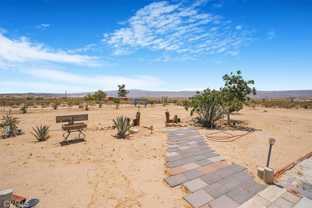 Welcome to Your Desert Oasis in Joshua Tree!
Discover this incredible opportunity to own a fully fenced 2.14-acre property in the heart of Joshua Tree, complete with a gated entrance and its own water meter. Surrounded by stunning mountain and desert views, this lot offers both natural beauty and thoughtful enhancements.
Enjoy peaceful outdoor living with water lines installed throughout the property, creating inviting spaces for relaxation and entertaining. A convenient outdoor bathroom and shower provide added comfort—perfect for hosting RV guests or embracing the open-air lifestyle.
Though you'll feel a world away, you're just a short drive from town, offering the perfect blend of seclusion and accessibility.
Don't miss out on this one-of-a-kind property—schedule your private tour today! adjacent property with a house can be purchased for an additional $550,000. LISTING ID:CV25136564