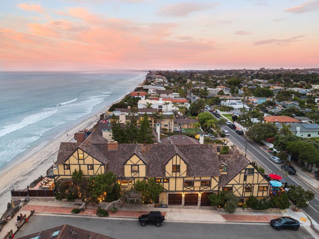 Sophisticated Oceanfront Estate located just steps from the vibrant heart of downtown Encinitas—yet perfectly tucked away, offering ultimate privacy and panoramic views high above the shimmering Pacific Ocean. This elegant legacy estate spans the length of the Oceanfront to Neptune Ave and offers over 6,800 square feet of refined coastal living. 6 spacious bedrooms and 6 luxurious bathrooms in the main home, multiple bonus rooms, a dedicated office, and architectural details that impress at every turn + Designer perfect 2bed/2bath guest house with separate entrance and fabulous designer kitchen. Soaring vaulted ceilings, bespoke woodwork, dramatic walls of glass, and exquisite onyx countertops create an ambiance of timeless sophistication. Enjoy the warmth of five grand fireplaces, dine alfresco in the serene, wind-protected garden courtyard with a wood-burning fireplace, or unwind on one of the many ocean-facing decks where every sunset feels like a private show. With a rare 5-car garage and an abundance of thoughtful design, this estate offers the epitome of Southern California luxury, endless living spaces for multi-generational living, and an abundance of splendor where every day feels like a five-star getaway.