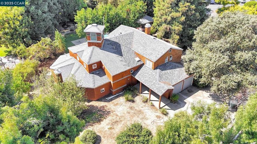 One-of-a-Kind Architectural Gem in North Fresno. Built in 1987 by an architect for his own family, this custom-designed 3,800 sq ft home is unlike anything you’ll find on the market today.  Step inside and you’ll discover a floor plan built for flexibility and entertaining. The spacious family room/den can be completely closed off for privacy and features its own freestanding fireplace and sitting nook. While the main living room soars with natural light, redwood ceilings, and custom light boxes line the entry way perfect for displaying art or décor. A dual fireplace connects the Livingroom and primary spaces for warmth and charm. Unique windows throughout frame the home beautifully, while hidden nooks and architectural surprises bring character at every turn, including a secret hideaway tucked behind a bookcase upstairs with sweeping views The primary suite is conveniently located on the main level and features a walk-in closet, spa-inspired bath with dual shower heads, and a rare Roman tub/shower combination. Upstairs, generous secondary bedrooms, abundant storage, and built-in bookcases line the walkway, adding both function and style. Outdoors is your private a pool, a large gazebo with outdoor bathroom and shower, and mature landscaping that provides beauty and shade