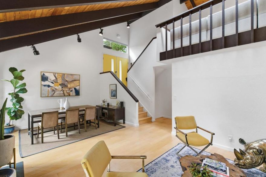 Nestled in the serene Montclair Hills, this architecturally striking contemporary home offers a blend of privacy, natural beauty, and convenience. With southern exposure on a functional 0.4-acre lot, the property enjoys tranquil wooded views. A rare find, the expansive fenced yard offers exceptional usable spaceideal for pets, gardening, or outdoor play. Inside, light maple floors connect the main living areas, leading to an open living and dining room with soaring ceilings, an art-tile fireplace, and a sun-filled deck. A flexible loft overlooks the main level and includes a convenient laundry roomperfect for a home office or creative retreat. The updated kitchen features stainless steel appliances, stone countertops, and a charming breakfast nook. A bedroom on each level provides versatile living options. The primary suite spans the lower floor with an en-suite bath, private deck, and access to a secluded outdoor seating areagreat for yoga, a hammock, or quiet reflection. Two generous storage rooms offer rare additional space. Ideally located minutes from Montclair Village, parks, top-rated schools, miles of trailheads, and just a few streets from the long-established Hills Swim & Tennis Club.