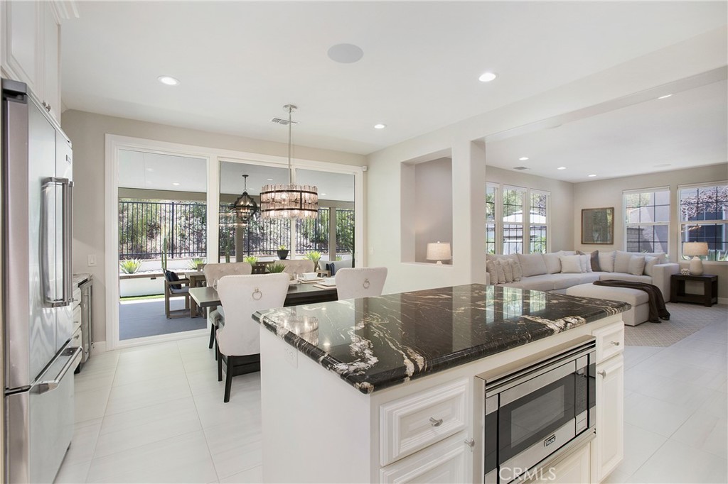 Welcome to the Dos Lagos area – where elevated design meets everyday ease.
Tucked into one of South Corona’s most desirable neighborhoods, the Citrus Springs Community this home isn’t just a property—it’s a lifestyle statement. Upon entry, you’re embraced by natural light pouring through large windows, a flowing open floor plan, and thoughtful touches that elevate the everyday.
The chef’s kitchen is both a showpiece and a high-performance space—featuring Viking appliances, an oversized 8-burner stove, a walk-in pantry, custom cabinetry, and show-stopping veiny countertops set against a striking backsplash. It opens seamlessly to the dining area and bar, complete with built-in cabinetry and a nearby built-in wine fridge—designed for effortless gatherings.
Recently remodeled, the living area now boasts a modern electric fireplace, while the dining area features upgraded sliding doors and uninterrupted views of the backyard—where indoor-outdoor living comes to life. Transition into the outdoor living space and enjoy a designer-inspired setting with a new laminated patio cover, built-in speakers, an oversized ceiling fan, and a dramatic chandelier. A custom modern fountain sets the tone, while turf provides a safe play area for little ones. Whether it’s wine with friends or dinner al fresco with family, the backyard was curated for connection.
Inside, the main floor offers a full bedroom and bath—perfect for guests or multi-generational living. Upstairs, you’ll find three additional spacious bedrooms, two full bathrooms, and a dedicated laundry room. The primary suite is generously sized for a king bed and includes a walk-in closet and private water closet.
Additional upgrades include a newer oversized AC unit with added vents, surround sound throughout, oversized ceiling fans, plantation shutters, a newer water heater, upgraded garage door, and fresh interior and exterior paint. Even the landscaping—front and back—has been recently refreshed.
This isn’t just a home—it’s the one you’ve been waiting for. And in Dos Lagos, homes like this don’t come often.