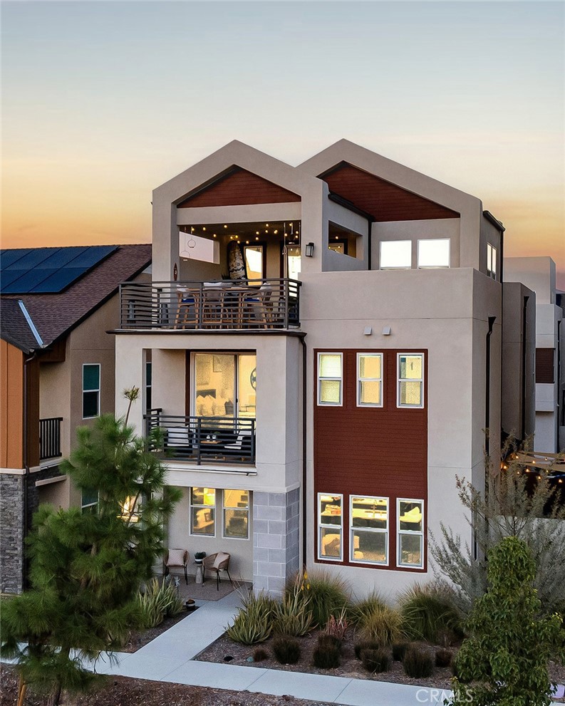 Welcome to 233 Tank, a modern move-in-ready detached home offering 2,344 sq ft of thoughtfully designed living in the Solis Park enclave of Irvine’s Great Park Neighborhoods. Sunlit and open, the great room flows into a chef-inspired kitchen with an oversized island, quartz countertops, upgraded cabinetry, and abundant storage, while LVP flooring, automated blinds, and a smart-home system make everyday living easy. Step outside to a string-lit patio perfect for BBQs and casual gatherings. Upstairs, the primary suite features a spa-like bath, walk-in closet, and private balcony; two additional bedrooms, a full bath, same-floor laundry, and a flexible loft/home office complete the level. The third-floor bonus room opens to a rooftop deck with mountain views, a great spot for golden-hour snacks or stargazing. Thoughtful upgrades include fully paid solar, whole-home water filtration and soft-water system, security system, and an attached 2-car garage. Built in 2024, this 3 bed plus loft and bonus room, 2.5 bath home blends clean finishes with practical storage and adaptable spaces. As a resident of the Great Park Neighborhoods, you’ll experience resort-style living with 9 pools, 12 clubhouses, 12 parks, 16 playgrounds, 2 dog parks, 14 sports courts, outdoor kitchens and BBQ areas, a coffee shop, and an outdoor fitness park; plus, the Bosque Trail and a network of scenic walking and biking paths weave throughout the community, connecting you to parks, gardens, and recreational spaces—perfect for an active, outdoor lifestyle—with walking distance to Solis Park School (K–8) and Portola High, and easy access to Great Park Sports Complex, Great Park Live, Irvine Spectrum, Woodbury Town Center, Cypress Village, and the 5, 133, and 241.