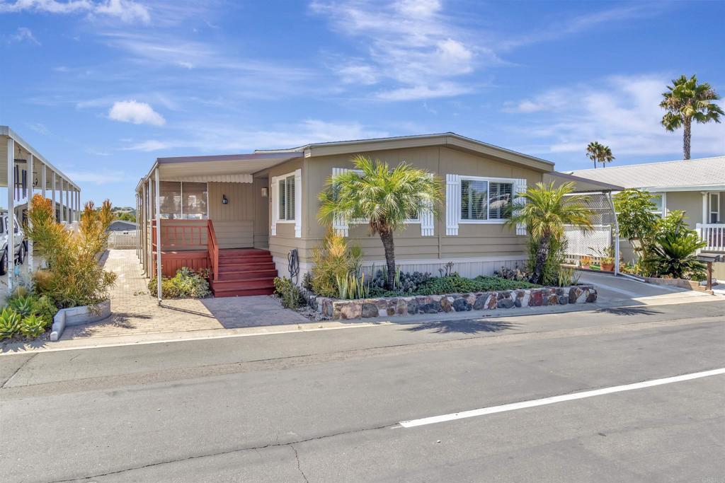 Very nice Mobil Home! Well maintained. New Carpet and Paint. Washer and Dryer to stay. Great location! Accross the street from the pool and Clubhouse. 2 sheds stay. Park 2 cars in the carport. Drought tollerant plants in front planter. Large Sunroom off the kitchen.